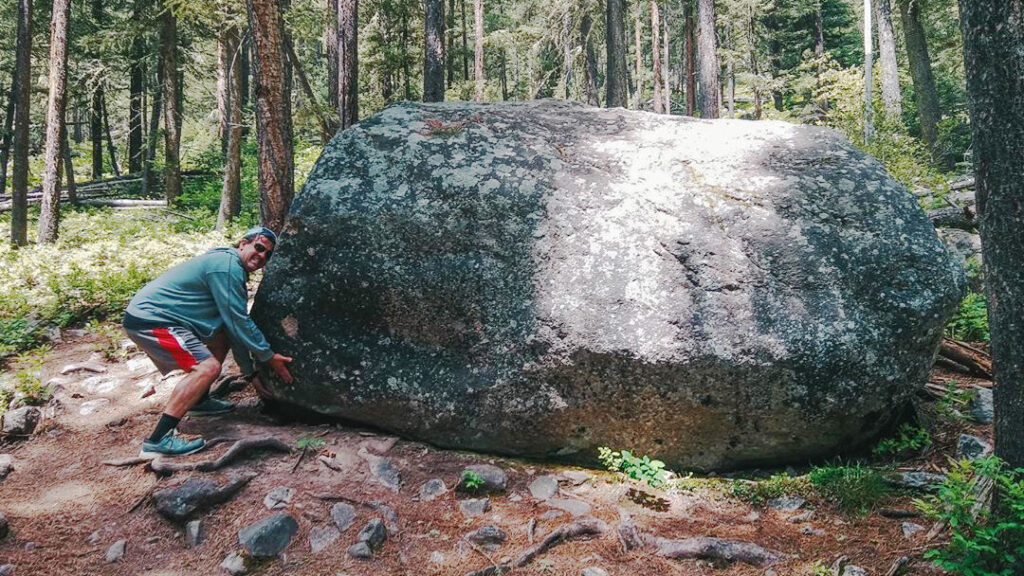 Eric pretending to try to lift a boulder