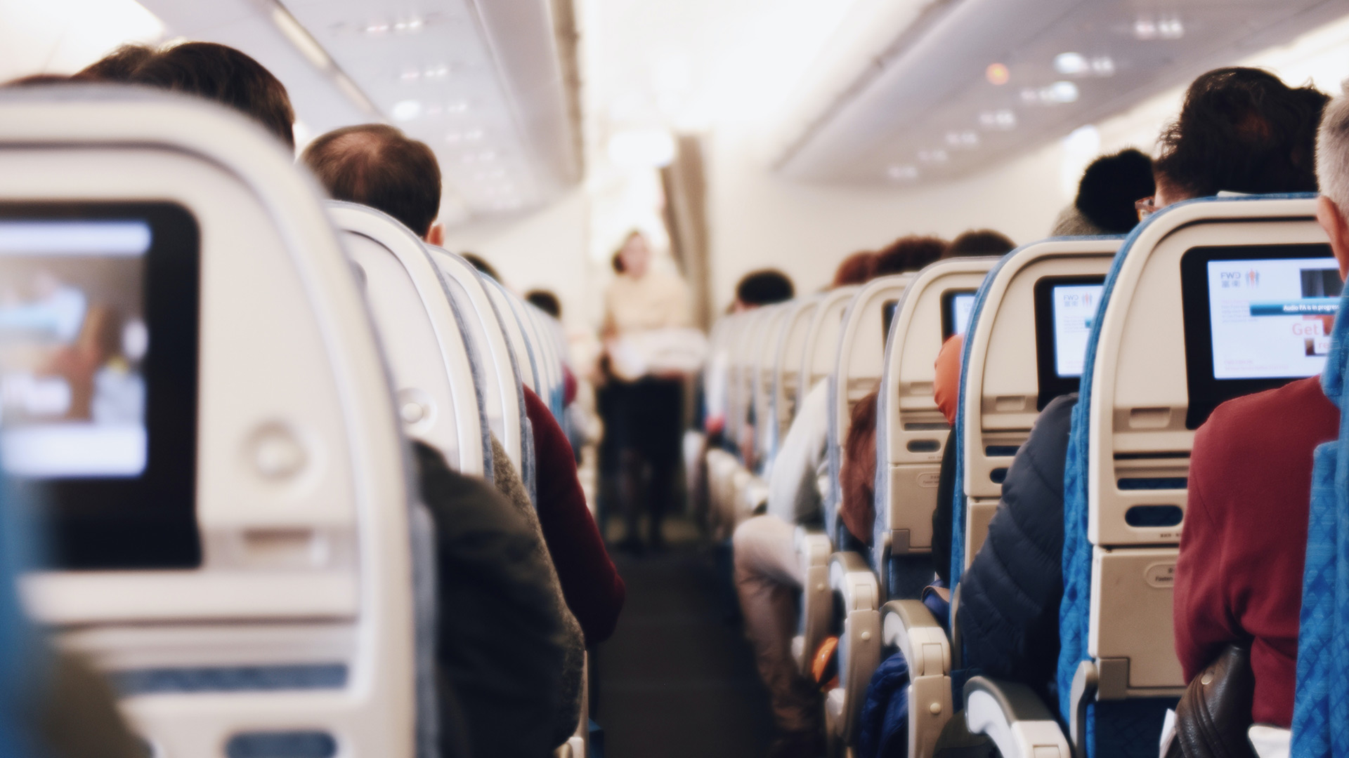 People sitting in airplane seats (Suhyeon Choi - Unsplash.com)