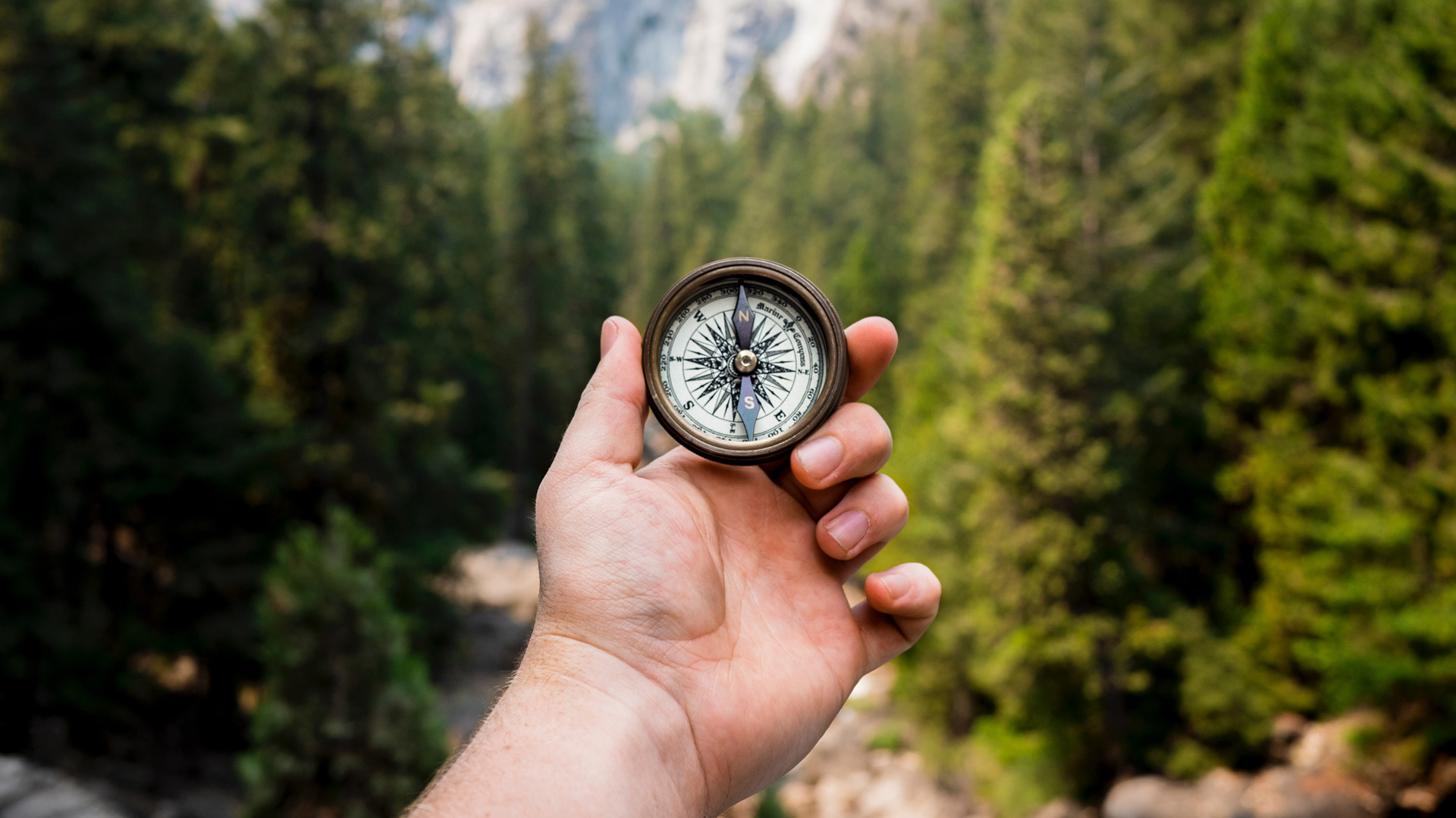 Outstretched hand holding a compass. (Jamie Street - Unsplash.com)
